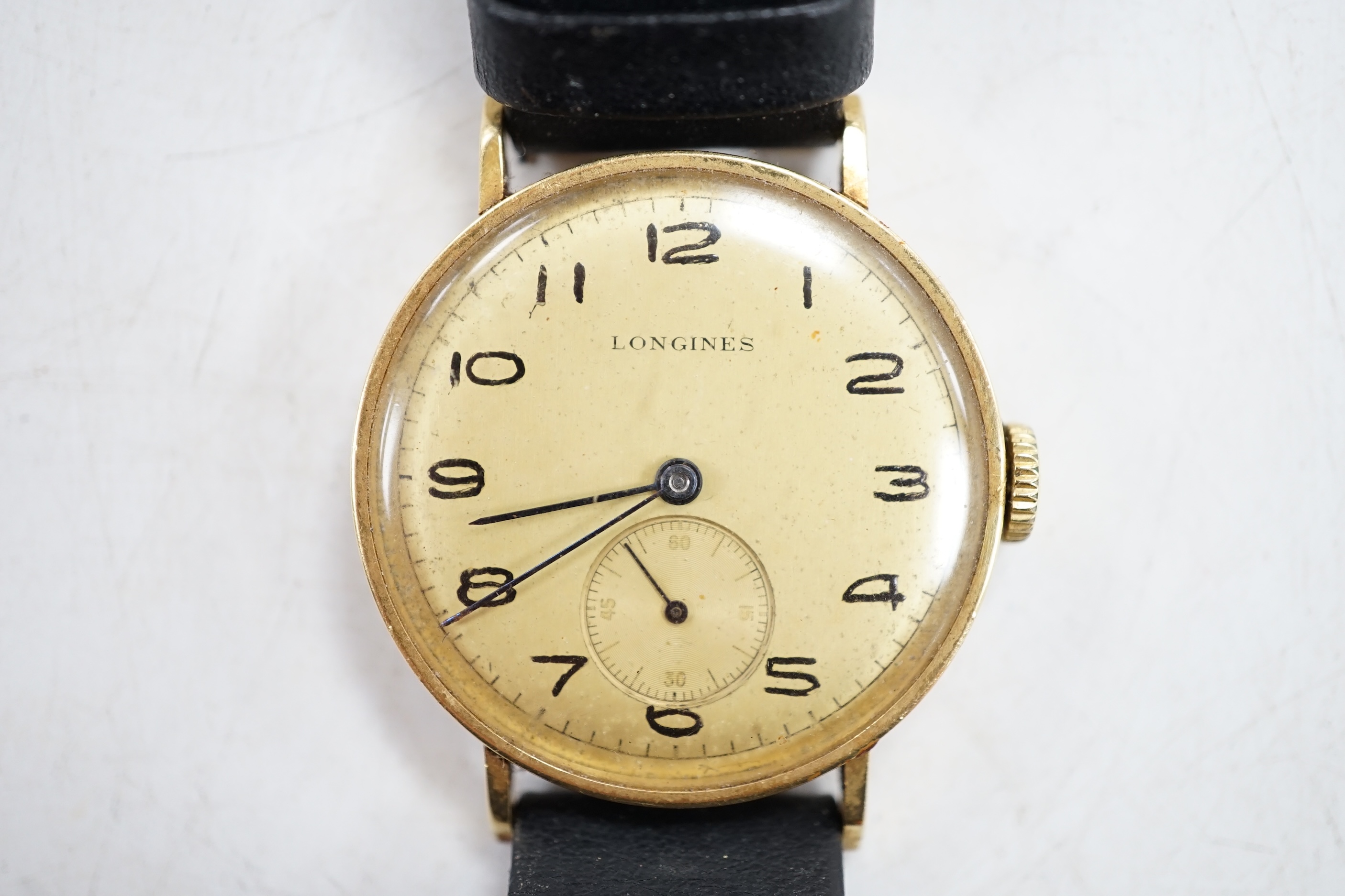 A Longines gentleman's 18ct gold wrist watch, with subsidiary seconds. Condition - appears to run, gauging to side, otherwise fair